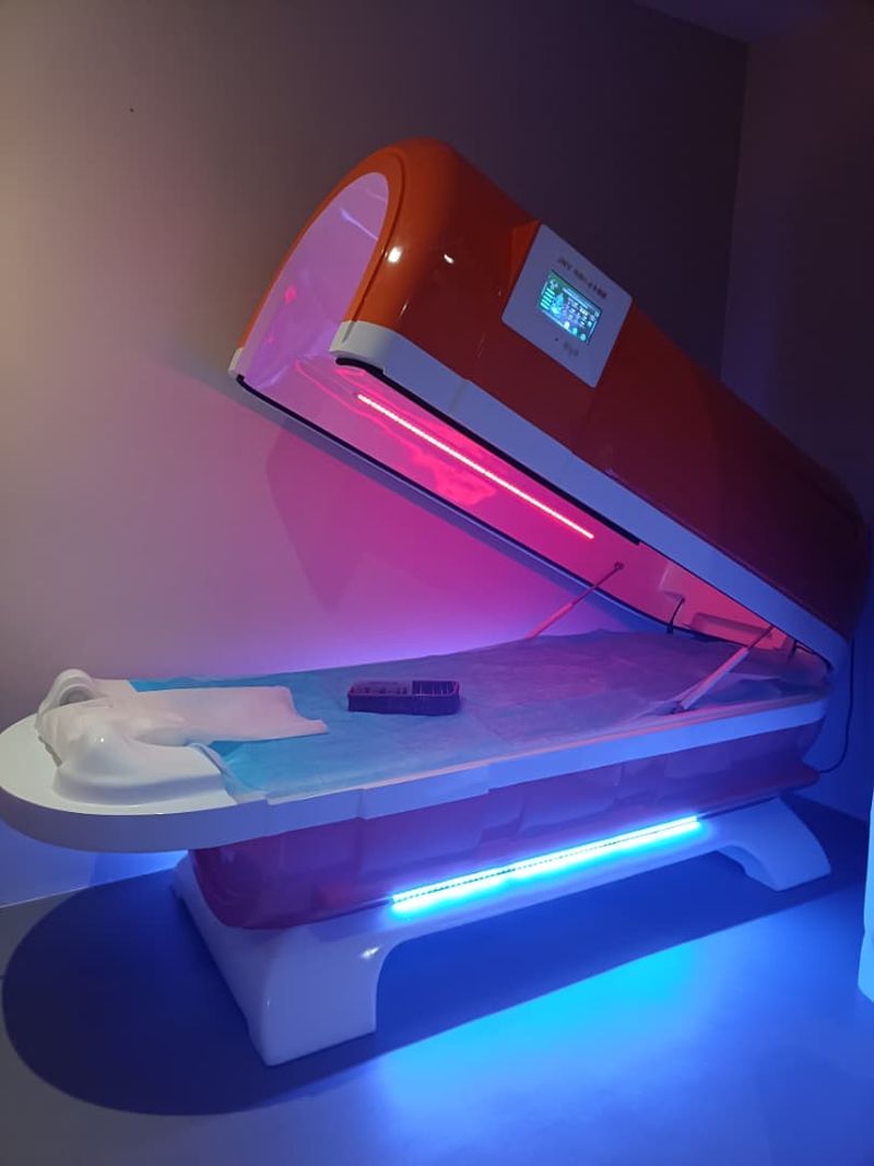 JNV wellness capsule glowing with pink and blue light